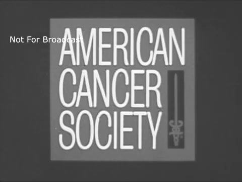 The still features the logo of the American Cancer Society in a stark, monochrome design typical of the 1960s. The text 'AMERICAN CANCER SOCIETY' is prominent, likely intended to grab attention for awareness purposes. The inclusion of a medical symbol hints at the organization's focus on health and cancer research. The overlay 'Not For Broadcast' indicates that this image is part of archival material not intended for public or commercial airing.