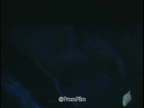 The still from the 1968 National Safety Council PSA highlights the hazards associated with driving in inclement weather. The image likely features a close-up of wet pavement, creating a moody, reflective surface that suggests danger. The presence of fallen leaves and possibly snow or ice adds to the precarious nature of driving conditions.  The accompanying commentary emphasizes the importance of awareness – warning against skidding due to worn tires, overloaded vehicles, and excessive speed. The visual serves as a cautionary reminder for drivers to be vigilant and maintain their vehicles properly to avoid potential accidents on slippery surfaces. Overall, the aesthetic and context drive home the message of safety and caution in changing weather conditions.