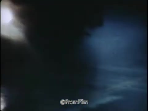 The 16mm still from the 'National Safety Council PSA - 1968 - Tire wear and tire pressure' presents a moody and atmospheric scene. The visual likely highlights a dimly lit environment that conveys a sense of caution and urgency. The interplay of light and shadow enhances the ominous tone, perhaps suggesting visibility challenges during adverse weather conditions.  The context implies that the imagery serves as a warning about the hidden dangers of driving in challenging conditions, such as rain, leaves, and slippery surfaces. The focus on tire wear and pressure emphasizes the importance of vehicle maintenance to avoid accidents. The overall message encourages viewers to be aware and proactive about their driving habits to ensure safety on the road.