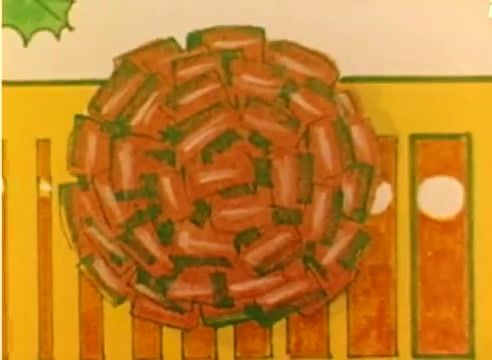 The still from the 'Kodak 1977 Sales Film' features a vibrant, animated representation of a circular arrangement of red packages or presents, all tied with green ribbons. The background is a bright yellow with hints of festive elements, such as holly, enhancing the Christmas theme. The image captures the spirit of the holiday season, aligning with the film's promotional intent for Christmas.