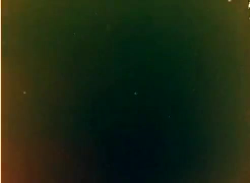 The still captures a moment from a 16mm silent color negative of the Kodak 1977 Sales Film. It features Michael Landon and Dick Van Dyke, likely showcasing holiday themes as it was produced in anticipation of the Christmas season. The image reflects the vintage look of the era, typical for promotional materials of the time.