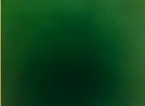 The still from the 'Kodak 1977 Sales Film' features a color negative that appears predominantly green and lacks distinct imagery or subjects. It represents the visual style of silent film production, indicative of the era and the film's promotional intent leading up to Christmas.