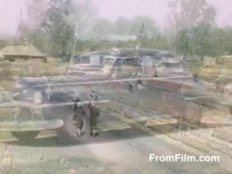 This 16mm still from 'The Tulip Film,' showcasing home movies from 1948-1950, captures a serene moment in Holland, Michigan, prior to the Tulip Time Festival. The footage, rendered in vibrant post-war Kodachrome, features blooming tulips, vintage vehicles, and lush landscapes, reflecting a nostalgic glimpse of a bygone era. It’s a delightful tribute for anyone passionate about tulips and horticulture.