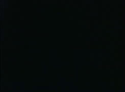 The still from the 16mm print of 'My Three Sons Theme song intro/outro' appears mostly black, indicating a lab reject. In the lower left-hand corner, a faint object is visible, but the overall image lacks clarity and detail.