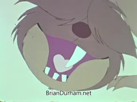 The still from the 'American Medical Association PSA - 1960's' features a cartoonish character with a wide, expressive mouth showcasing exaggerated teeth and a playful demeanor. The image likely aims to convey a message about dental health or hygiene, characteristic of public service announcements from that era. The colors and style reflect the animation trends of the 1960s.