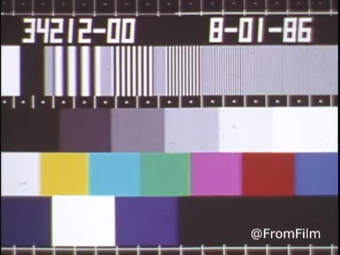 The still features a test pattern commonly used in video production and film, with a grid layout and various color bars, grayscale elements, and stripes. It indicates testing of equipment or calibration, likely from a tape-to-film transfer process. The date “8-01-86” suggests it dates back to January 8, 1986. The image is color-rich, designed to assess color accuracy and contrast in the visual output.