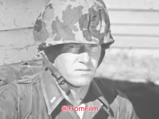 The still from the 'US Marines recruiting PSA' features a focused young Marine wearing a camouflage helmet. His serious expression conveys determination and readiness, embodying the qualities of leadership and discipline emphasized in the voice-over. The context highlights the benefits of military service, particularly in developing skills that are valuable in civilian life. The visual reinforces the message: serving as a Marine officer is portrayed as a significant and honorable choice.