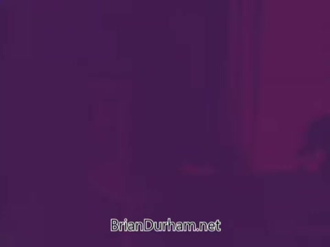 The still from 'Colgate Burst - low suds laundry detergent' presents an abstract, purple-toned image. The focus appears to be on visual effects emphasizing the product's qualities, with a possible emphasis on low suds, but specific details are unclear. The branding is subtly integrated, suggesting a promotional context.