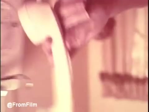 The still from 'Bounty Commercial Threaded Backwards...' shows a hand gripping a vintage telephone receiver. The setting has a soft, warm tone, characteristic of older commercials. The background is slightly blurred, suggesting a domestic environment typical of the period. The image conveys a sense of nostalgia and captures a unique perspective by being edited in reverse, adding an intriguing twist to the usual narrative of commercials.