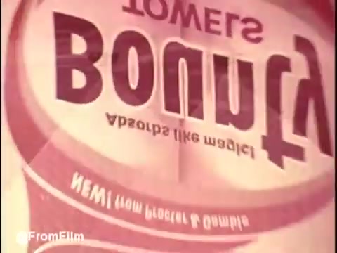 The still from 'Bounty Commercial Threaded Backwards...' features a backward display of the word 'Bounty.' The print shows a blend of muted colors typical of 16mm film, providing a nostalgic feel. The text appears inverted, creating a unique visual that hints at the theme of the project. The image captures the essence of experimental editing and the retro style of vintage commercials. Overall, it's an intriguing glimpse into a creative editing technique.