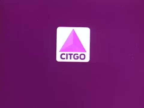 The still features the Citgo logo against a solid purple background. The logo consists of a triangular shape in shades of purple and the word 'CITGO' in bold black letters below it. The design emphasizes simplicity and brand recognition.