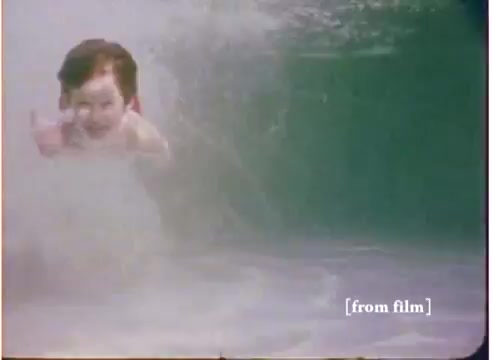 The still from the 16mm commercial features a child swimming underwater, likely showcasing the 'flying submarine' toy. The film lab paperwork indicates that it dates back to 1972. The image captures a playful underwater scene, emphasizing the imaginative appeal of the toy. Additionally, there are two versions of the soundtrack available, with one explicitly labeled as 'DO NOT USE.'