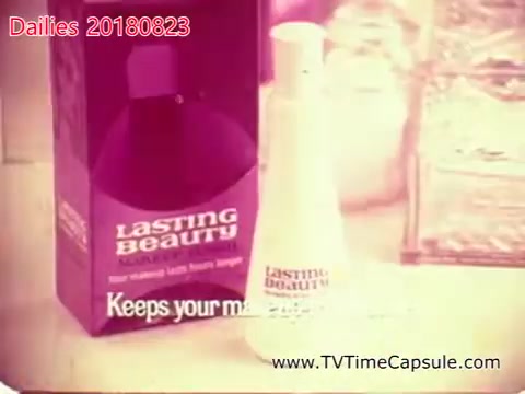 The still features a product advertisement for 'Lasting Beauty,' a cosmetic item, in a retro style typical of past commercial aesthetics. The product is displayed prominently in front of a purple box, with the text 'Keeps your makeup' partially visible, suggesting it may be a makeup setting spray or similar. The overall look is colorful and evocative of vintage advertising techniques.