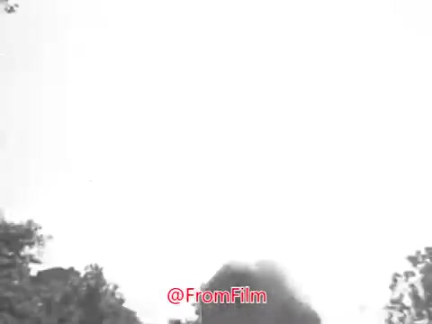 The still from 'Camp Fire Girls PSA - 1969' likely features a grayscale image depicting a campfire scene, potentially involving nature or outdoor activities typical of the Camp Fire Girls organization. The visual may appear slightly warped, consistent with older film quality, and the soundtrack could contribute to a nostalgic or atmospheric feel. The overall vibe captures a moment of camaraderie and the spirit of outdoor adventure.