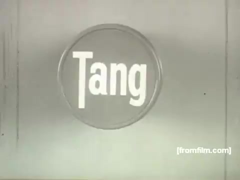 This still from the 1958 Tang commercial features a simple design with the word 'Tang' prominently displayed in bold, white letters against a neutral background. The circular composition emphasizes the brand, reflecting the minimalist and stylized animation aesthetic characteristic of UPA. The image captures the vintage charm of mid-century advertising.