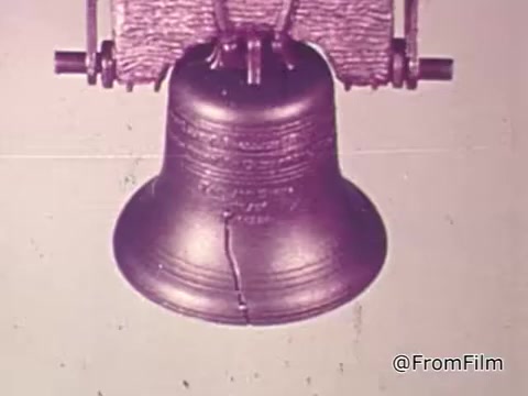 The still features a close-up of the Liberty Bell, capturing its distinct crack and details. The background is plain, emphasizing the bell as a symbol of freedom. The accompanying voiceover discusses the ongoing struggles against oppression, juxtaposing the bell’s historical significance with the notion that true liberty cannot exist while others face injustice.
