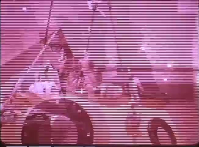 The still from the trailer of 'Around the World Under the Sea' features a group of individuals engaged in underwater exploration activities. The scene conveys a sense of adventure with a focus on marine technology. Various equipment and instruments are visible, hinting at scientific research or exploration themes. The coloring gives a retro, atmospheric feel, typical of classic film trailers, emphasizing the underwater setting.