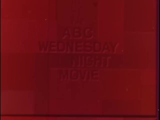 The still features a bold, embossed title reading 'THE ABC WEDNESDAY NIGHT MOVIE' set against a deep red background. The text is prominent and centered, capturing the essence of a classic television bumper from the late 1960s to early 1970s. The overall aesthetic is simple and iconic, reflecting the graphic style of that period.