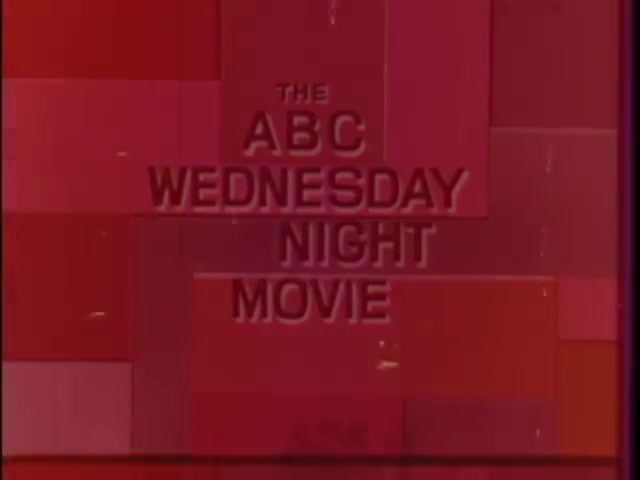 The still features a vibrant red background with the text 'THE ABC WEDNESDAY NIGHT MOVIE' prominently displayed in bold, white letters. The design is simple yet striking, typical of 1960s television aesthetics, and reflects the era's graphic style. The overall composition suggests an inviting atmosphere for viewers tuning in for the midweek film feature.