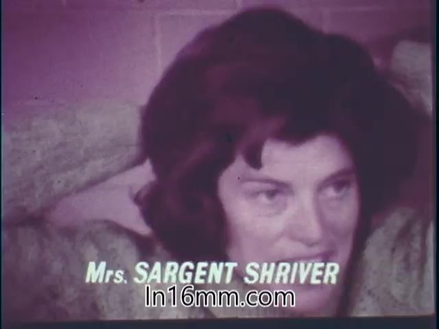 The still from the 1968 PSA features a woman identified as Mrs. Sargent Shriver. She appears to be in a setting related to fitness, engaging with the camera. The visual quality reflects the characteristics of 16mm film, likely emphasizing themes of health and wellness inherent to the 'Special Fitness Awards' message.