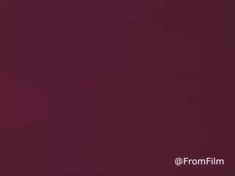 The still displays a raw, unprocessed frame from a 1970s Jello commercial, characterized by a muted maroon color without any color correction. The image likely lacks clarity and vibrancy, reflecting the original film's unedited state.