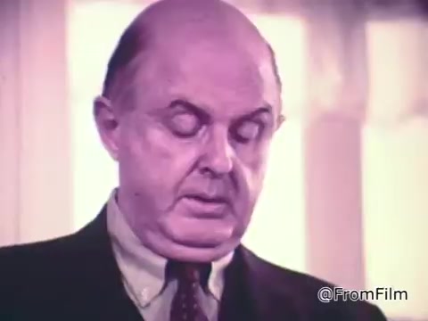 The still from the 'Baggies alligator storage bags commercial' features a man in a suit, looking serious while speaking. He is likely making a point about the effectiveness of Baggies alligator bags in preventing freezer burn, emphasizing their protective qualities with a lighthearted tone contrasting the serious image of the alligator. The setting appears bright, highlighting the product's appeal.