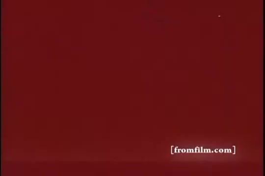 The still features a solid red background, typical of a vintage aesthetic from a 16mm print. It lacks detailed imagery, focusing instead on color saturation, indicative of the style of advertising in the 1970s era. The presence of the watermark suggests it's part of an archival collection.