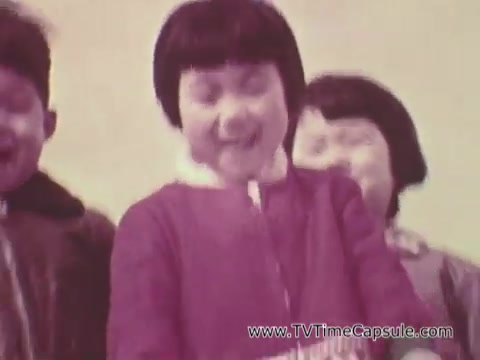 The still from the 'Christian Children's Fund PSA' features a group of joyful children, primarily focused on two with distinct hairstyles, smiling and engaging with the camera. The vibrant colors and expressive faces convey a sense of happiness and innocence. The background is simple, allowing the children's emotions to take center stage, highlighting the theme of joy and solidarity often associated with such public service announcements.