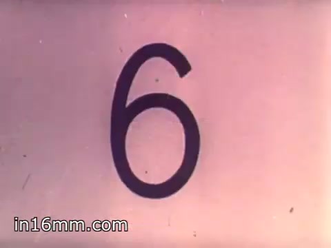 The 16mm still from 'Air Force Reserve Recruiting - 1968 - Air Crews' features a large, bold number '6' on a light background. The design is simple and striking, likely serving as a countdown or emphasis within the film's context. The style reflects the graphic design trends of the late 1960s.