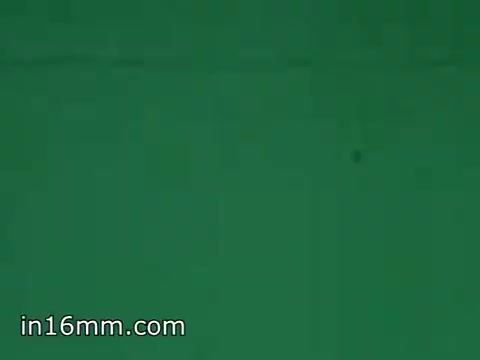 The still features a simple green background, likely part of a visual or promotional element from the 1968 film focused on Air Force Reserve recruitment for air crews. The color could suggest a focus on uniforms, equipment, or other visual content related to the Air Force's messaging at that time. The composition is minimalistic and may have been intended for a specific context within the film.