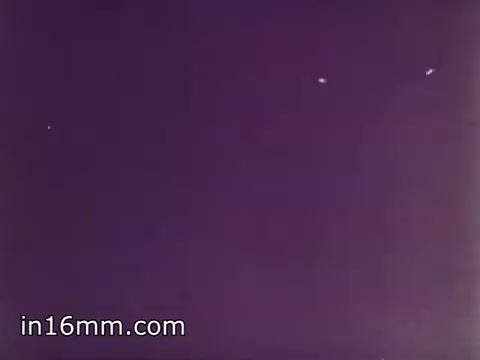 The still from 'Air Force Reserve Recruiting - 1968 - Air Crews' likely features a visual depicting aircraft in flight, possibly showcasing various aircrew members or aircraft operations. The purple-tinted background suggests a stylized or edited look, typical of promotional materials aimed at attracting recruits to the Air Force Reserve. The image captures the essence of aviation and military service during that era, emphasizing teamwork and aerial prowess.