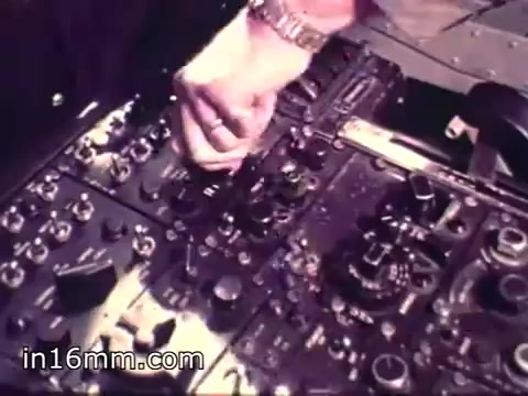 The still from 'Air Force Reserve Recruiting - 1968 - Air Crews' depicts a close-up of a hand adjusting controls on a cockpit instrument panel. The panel features various dials, switches, and knobs, highlighting the complexity of aircraft instrumentation. The setting suggests a focus on the technical skills required for aircrew positions, emphasizing the operational aspects of military aviation.