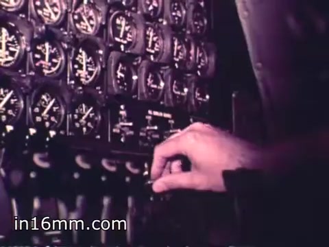 The still features a close-up of a hand adjusting controls on a cockpit instrument panel filled with numerous gauges and dials. The setting likely emphasizes the technical aspects of operating an aircraft, highlighting the precision and responsibility of aircrews in the Air Force Reserve during the 1960s. The image captures a moment of focus and professionalism, reflecting the recruitment message of the film.