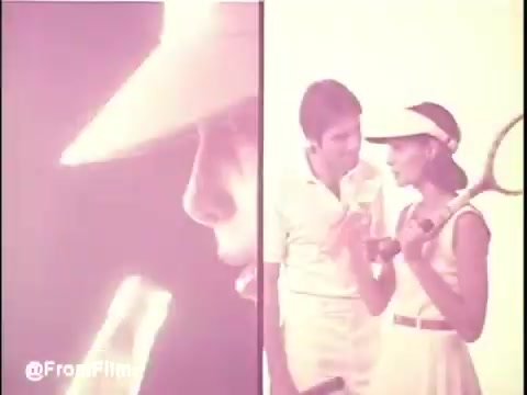 The still features a split image from a 1970s Orange Crush TV commercial. On the left, a close-up of a person's face, possibly enjoying a drink, while on the right, a couple dressed in white tennis attire engage with each other, holding a tennis racket. The color palette is warm, capturing the era's aesthetic. Perfect for evoking nostalgic vibes of leisure and refreshment.   Follow @FromFilm for more.