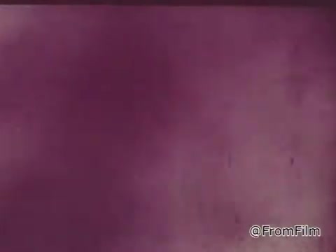 The still from the 1960s Chase and Sandborn Coffee commercial featuring race car driver Roger McClusky likely captures a dynamic moment that reflects the commercial's theme. Given the era, the color palette may appear muted or slightly faded, characteristic of 16mm film. The imagery would evoke a sense of excitement associated with racing and the promotion of the coffee brand, artistically emphasizing the connection between the speed of motorsport and the energy boost from coffee.