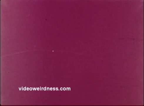 The still from the 16mm animated PSA by the American Dental Association features a simple background with a purplish tint. The focus is on the message 'Brush your teeth!' which aims to promote dental hygiene in a fun and engaging way typical of 1960s animations. The aesthetic reflects the era's style, characterized by bright colors and playful animations.