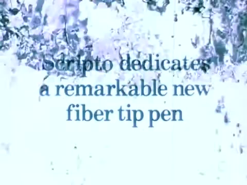 The still features the text 'Scripto dedicates a remarkable new fiber tip pen' set against a textured background with abstract splashes of color, likely emphasizing creativity and innovation related to the product. The overall aesthetic suggests a dynamic and engaging commercial environment.