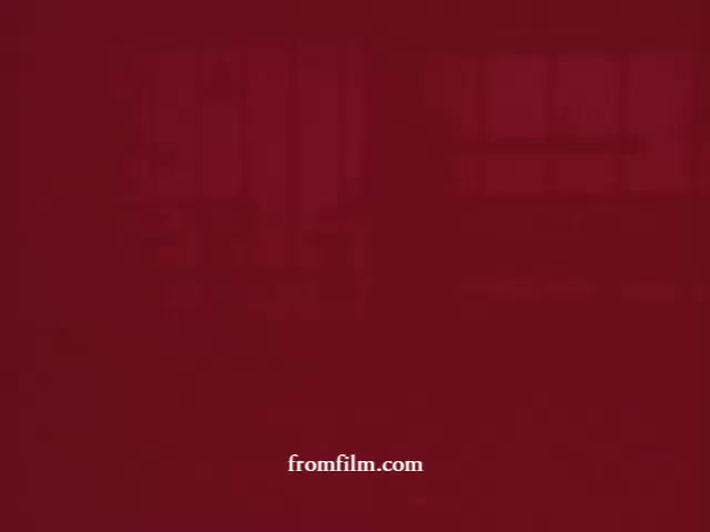 The still from 'Cleaning products: Glamolene, Liquid Glory and Spray-n-Vac' presents a simple, deep red background with the text 'fromfilm.com' subtly displayed. This minimalistic approach creates a striking visual that likely aims to evoke nostalgia for vintage cleaning product commercials from 16mm prints. The absence of logos and vivid imagery emphasizes the focus on the film itself and its context within the project.