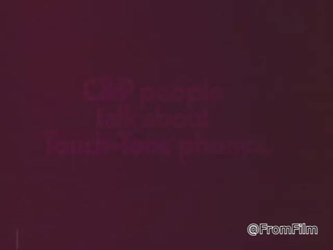 The 16mm still from the commercial features text that reads, 'C&P people talk about TouchTone phones.' It likely captures a promotional moment highlighting the benefits of TouchTone technology over traditional rotary phones, emphasizing convenience and efficiency in communication. The focus is on dialogue and customer experiences relating to the new technology.