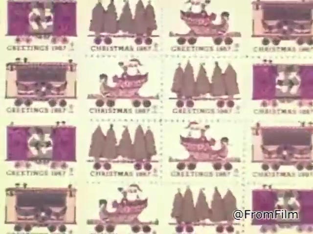 The 16mm still features a grid of Christmas seals from 1967, showcasing playful and festive illustrations. The seals include designs with trains, Christmas trees, and children, capturing a nostalgic holiday spirit. The color palette consists of warm tones and festive themes, reinforcing the association with the Christmas season. Each stamp is labeled 'Christmas 1967,' emphasizing its historical context. This visual is not only a representation of a fundraising initiative by the National Tuberculosis Association but also a charming glimpse into holiday traditions of that era.