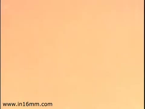 The still likely features a simple, warm-toned background, indicative of a 1970s aesthetic. It may serve as a visual backdrop for messaging related to tax responsibilities or the importance of filing taxes, aligning with the educational nature of government commercials. The minimalist design could emphasize clarity and focus on the informational content.