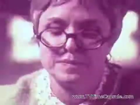 The still from the 'ScottTowels Commercial' features an older woman with glasses, portraying a thoughtful or concerned expression. She appears to be the focus of the scene, which likely emphasizes the product's usefulness in everyday situations. The overall aesthetic has a vintage quality typical of commercials from that era.