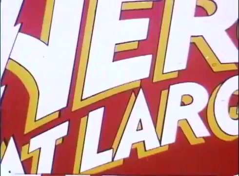 The still from the 'Hero at Large' movie promos features bold, stylized text prominently displaying the movie's title against a vibrant red background. The typography is lively, with a dynamic color scheme that includes yellows and whites, giving it a playful and eye-catching appearance typical of promotional materials from the late 1970s. This conveys the film's comedic and lighthearted tone, reflecting the overall essence of the story involving a man who becomes a superhero.