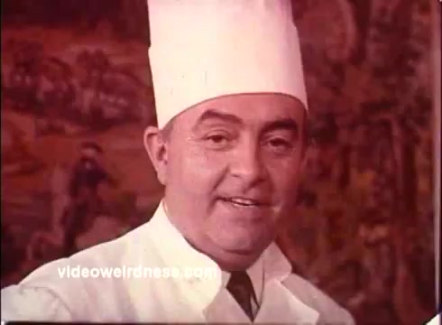 The 16mm still from the 'Blue Bonnet Margarine Commercial - 1970s' features a smiling chef in a white uniform and a chef's hat. The background appears to be a vibrant mural, adding a warm, nostalgic atmosphere to the image. The chef seems to be promoting the margarine with an inviting demeanor, typical of commercials from that era, which often emphasized home-cooked meals. The overall aesthetic reflects the 1970s style, focusing on charm and culinary appeal.   For more on vintage commercials, follow @FromFilm on Twitter or check out the YouTube channel.