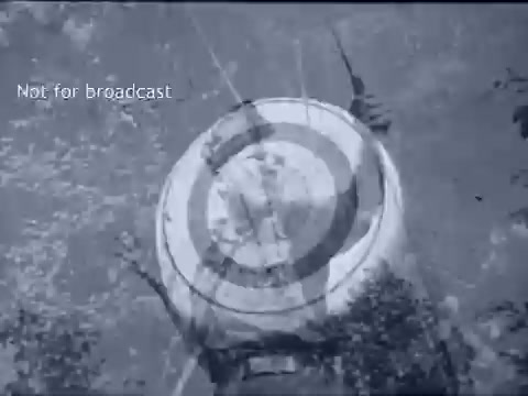The still from the PSA 'Scouting Rounds A Guy Out' features a round target, typical in archery or shooting contexts, shot in black and white. It's likely emphasizing skill development in outdoor activities. The caption 'Not for broadcast' indicates it's a private or archival piece rather than for public airing. The overall tone reflects the educational and adventurous spirit of Boy Scouts in the 1960s.