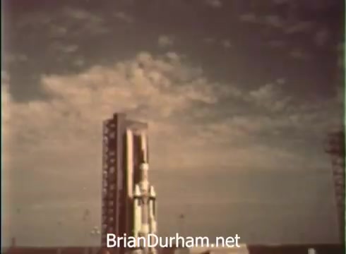 The still from the 1968 PSA features a rocket on a launch pad against a sky filled with clouds. The imagery symbolizes progress and the exploration of aerospace, highlighting the connection between collegiate pursuits and military service in the United States Air Force. The narrative reflects a transition from student life to a commitment to technological advancement and teamwork in aerospace endeavors.