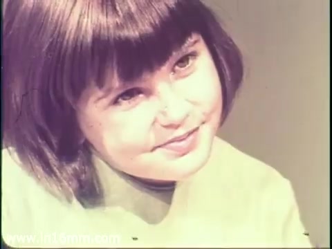 The still from the 1968 PSA features a young girl with a bob haircut and a thoughtful expression. The background appears to be a simple, neutral color, which draws attention to her. The PSA addresses the importance of measles vaccination, highlighting the potential severe consequences of the disease, including mental disabilities. This visual is likely intended to evoke concern and prompt action among viewers regarding public health.