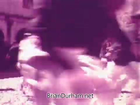 The still from the 'Pepsi commercial - Todos junto a Pepsi siempre libre y feliz' features a dynamic and lively scene, likely capturing individuals engaging in activities that convey joy and camaraderie. The film's vintage 16mm quality adds a nostalgic touch, enhancing the overall cheerful atmosphere associated with the brand. The imagery likely reflects the theme of unity and happiness tied to enjoying Pepsi.