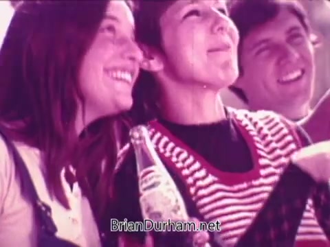 The still features a joyful group of young people together, smiling and enjoying bottles of Pepsi. They are dressed in casual attire, suggesting a carefree atmosphere. The image captures a sense of camaraderie and happiness associated with the Pepsi brand, reflecting the upbeat message of the commercial.