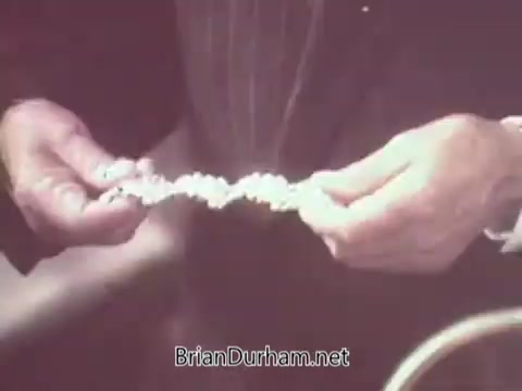 The still likely features a person holding a decorative food item or cracker, emphasizing the product's presentation. The scene appears warm and nostalgic, reflecting the promotional style typical of the 1970s, focusing on the quality and appeal of Nabisco Escort Crackers. The ambiance suggests a casual, inviting atmosphere, common in vintage advertisements.